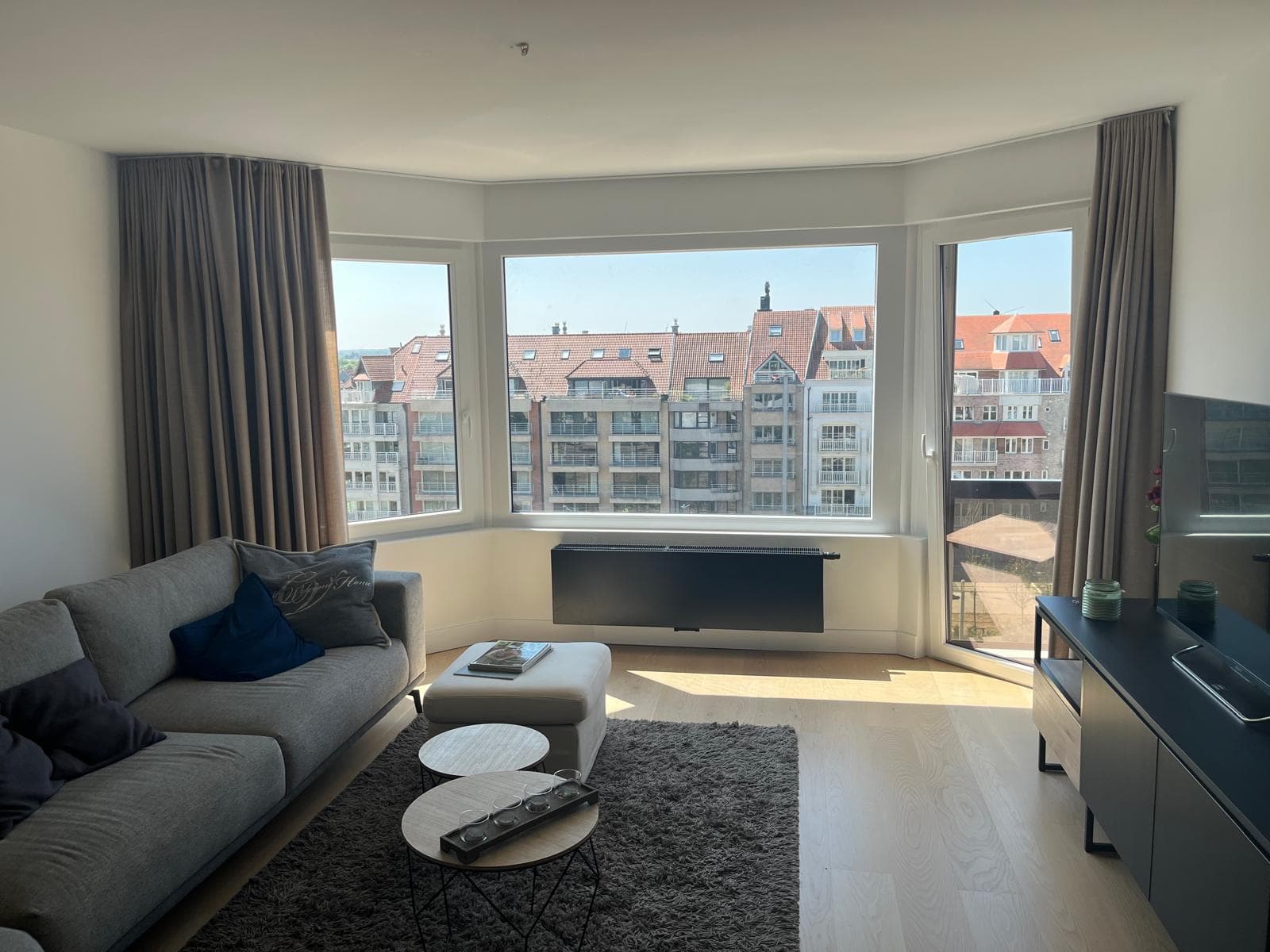 Living room with corner windows and rooftop view