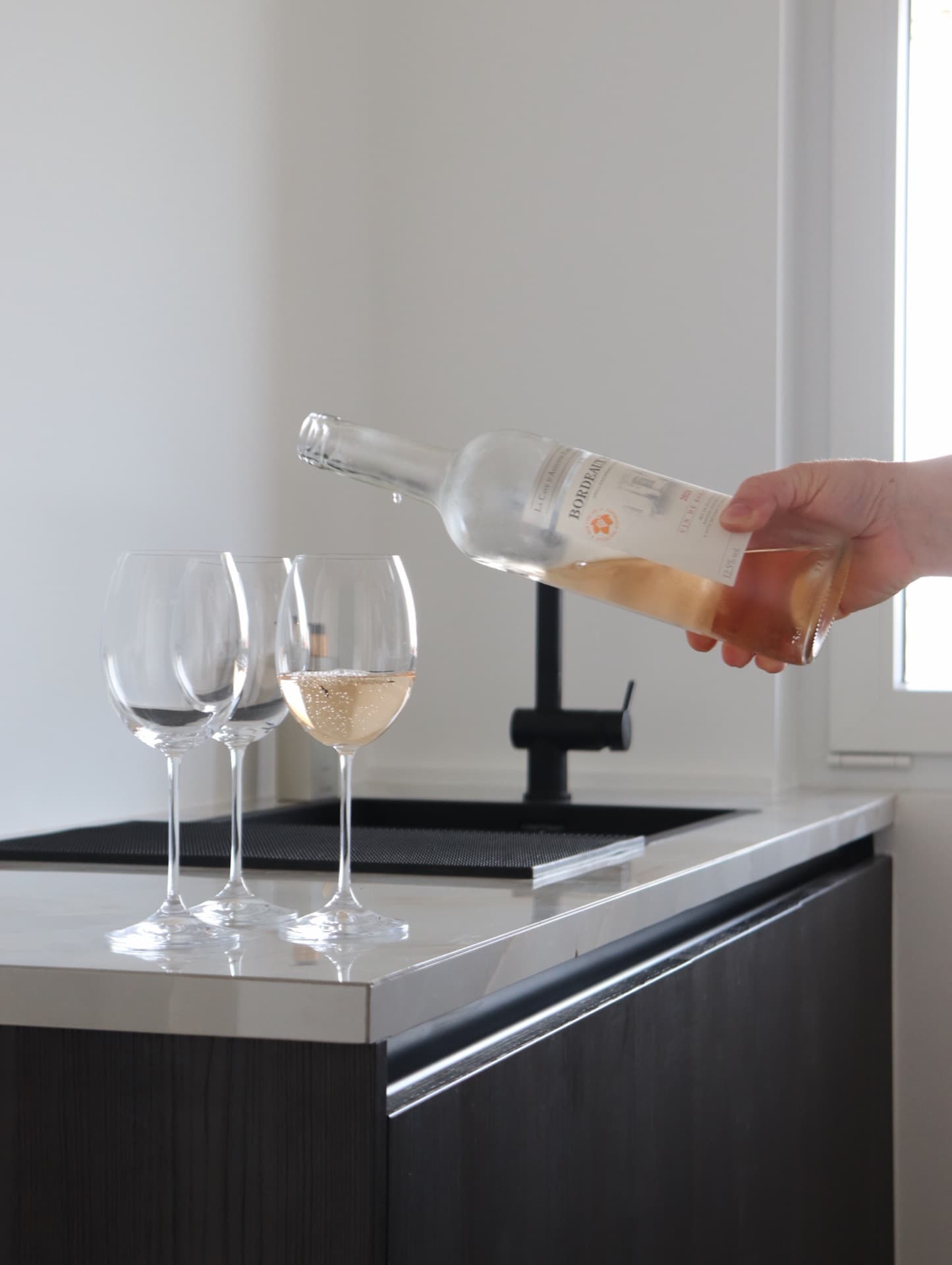 Pouring rosé in the kitchen